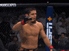 a man in a boxing ring with a sign that says manscaped