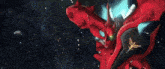 a close up of a red robot with a gold emblem on its chest