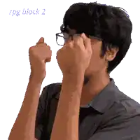 a man wearing glasses is covering his face with his hands and the words big duck 2 are visible in the background