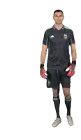 a man wearing a black adidas shirt and shorts is holding a pair of red soccer gloves