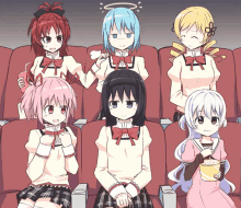 a group of anime girls are sitting in a theater eating popcorn