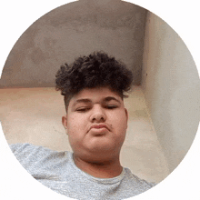 a young man with curly hair and a mustache is taking a selfie in a circle