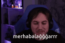 a man wearing headphones is laughing with the words merhabalaggarrr written on the bottom