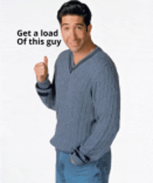 a man in a blue sweater giving a thumbs up sign