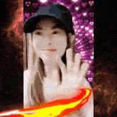 a woman wearing a baseball cap is waving her hand in front of a purple background