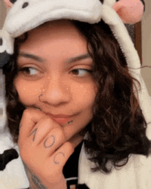 a woman with a tattoo on her finger that says no c