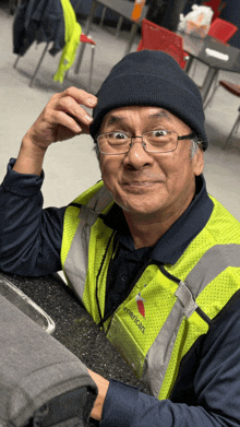a man wearing a yellow vest that says " american "