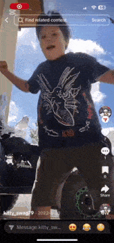 a boy wearing a black shirt with a dragon on it