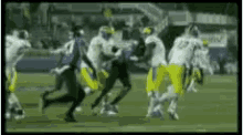 a football player with the number 12 on his jersey is being tackled