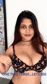 a woman in a floral bra with the words one two three lets see below her