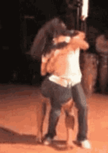 a couple of people are hugging each other on a stage .