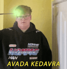 a man wearing a black hoodie that says avada kedavra on it