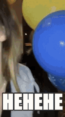 a woman is surrounded by balloons and the word henehe is on the screen