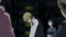 a man in a suit and bow tie is making a funny face in a dark room .