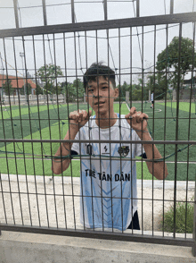 a young boy wearing a shirt that says tre tan dan