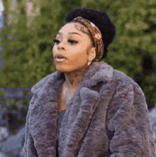 a woman wearing a fur coat and a headband