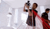 a man is taking a picture with a camera in a room