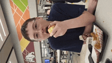 a boy is eating an apple and drinking a milk carton that says fearless on it