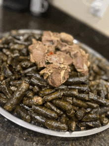 a tray of food with a piece of meat on top