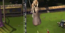 a giraffe and a rhino are hanging from a rope on a field