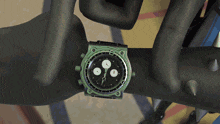 a watch on a person 's wrist shows that it is almost 3:00
