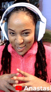 a woman wearing headphones with the word anastasi on the bottom left