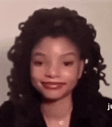 a close up of a woman 's face with the letters jc on the bottom