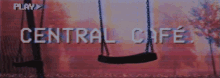 a sign for central cafe shows a swing in the foreground