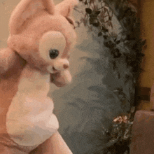 a close up of a person holding a stuffed animal in their hands .