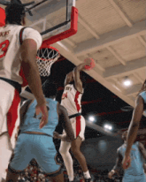 a basketball player with the number 24 on his jersey goes up for a dunk