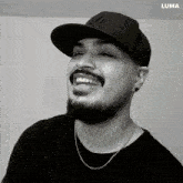a black and white photo of a man wearing a new york hat