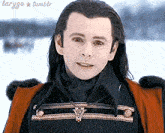 a man with long hair is wearing a black jacket and a red coat