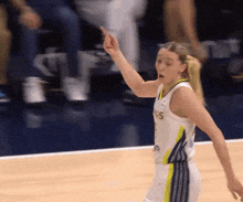 a female basketball player wearing a jersey that says ncs on it