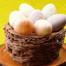 a cake in the shape of a bird nest with eggs on top