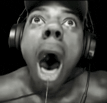 a man wearing headphones is making a surprised face