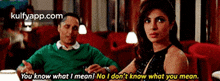 a man and a woman are sitting in a restaurant and the woman is saying you know what i mean