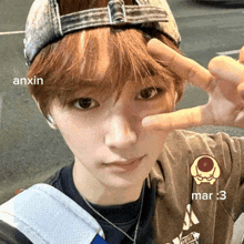 a person wearing a hat and a t-shirt that says mar 3 on it