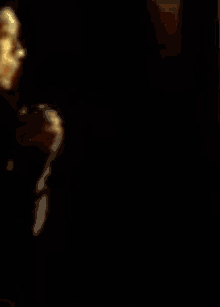 a blurry picture of a woman 's face with a yellow background