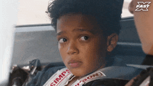 a young boy wearing a simpson seat belt