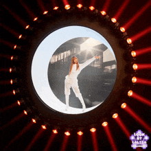 a woman in a white jumpsuit is standing in a circle of lights with the words look at lalisa on the bottom