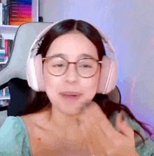 a woman wearing glasses and headphones is smiling