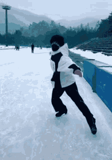 a person is skating on a ice rink with a sign that says tfs
