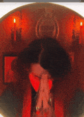 a man wearing a red collar with his hands folded