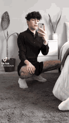 a person taking a selfie with a tiktok watermark on the bottom