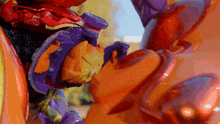 a close up of a toy that looks like a purple and orange robot