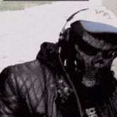 a man wearing headphones and a hat that says vcr