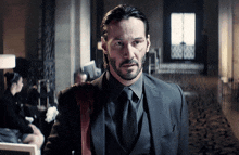 a man with a beard wearing a suit and tie