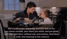 a man and a child are sitting at a table with a quote that says she 's so beautiful