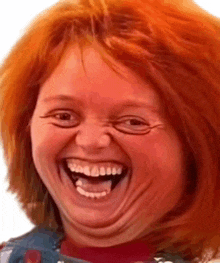 a close up of a person 's face with red hair