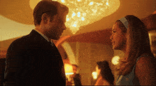 a man and woman are looking at each other in a room
